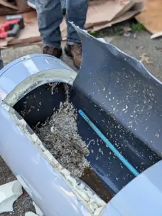 Cut-open water heater showing heavy mineral sediment buildup at the bottom of the tank in a Dayton-area home