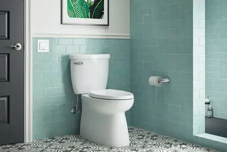 Side view of a white Easy Clean skirted toilet with a smooth porcelain base installed in a Beavercreek, Ohio bathroom.