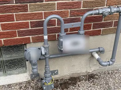 Exterior natural gas meter, regulator, and shutoff on a brick Dayton-area home where Honey Go Fix It began a gas leak test