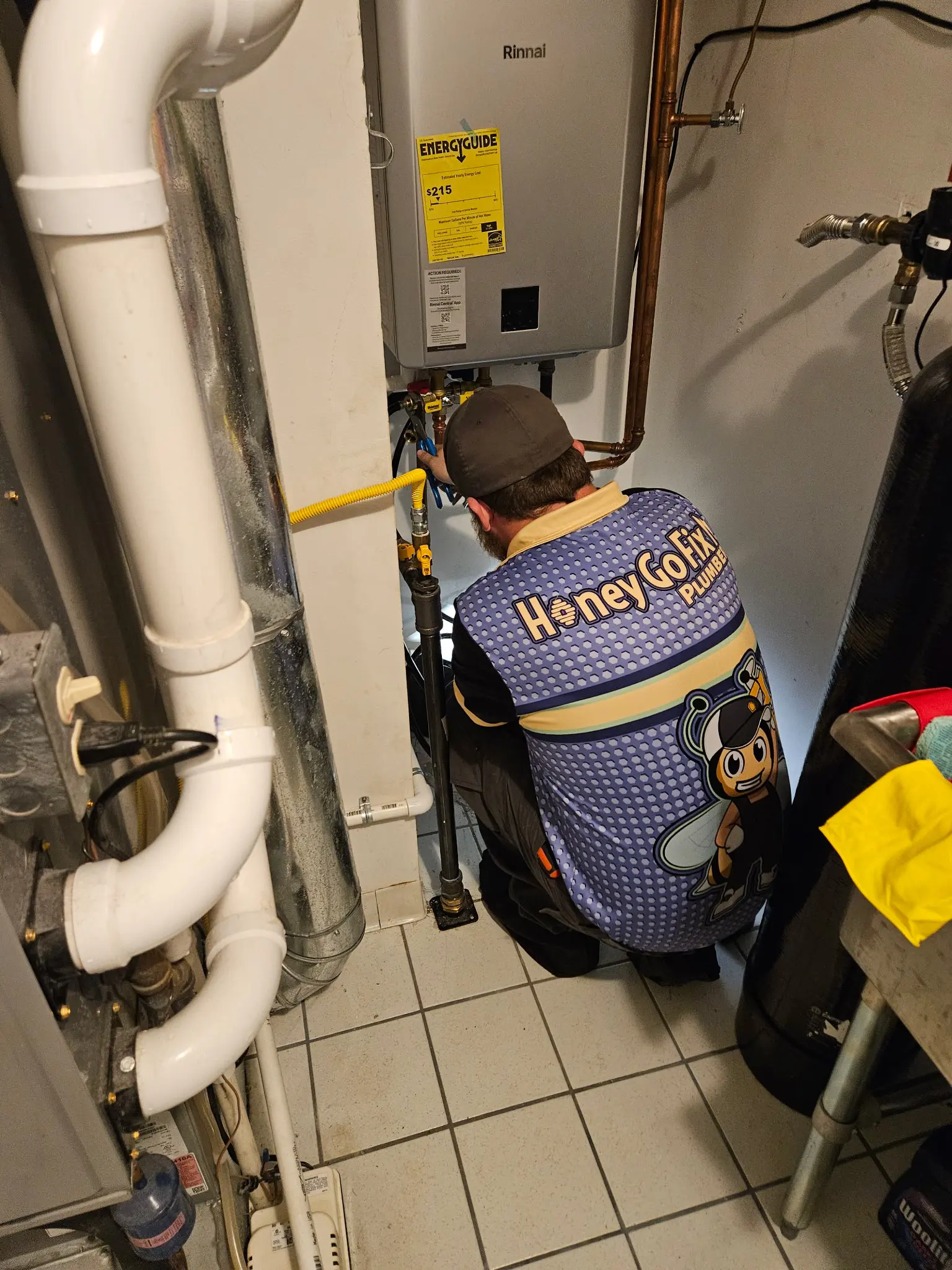A professionally organized mechanical room in a luxury Centerville home featuring modern plumbing connections.