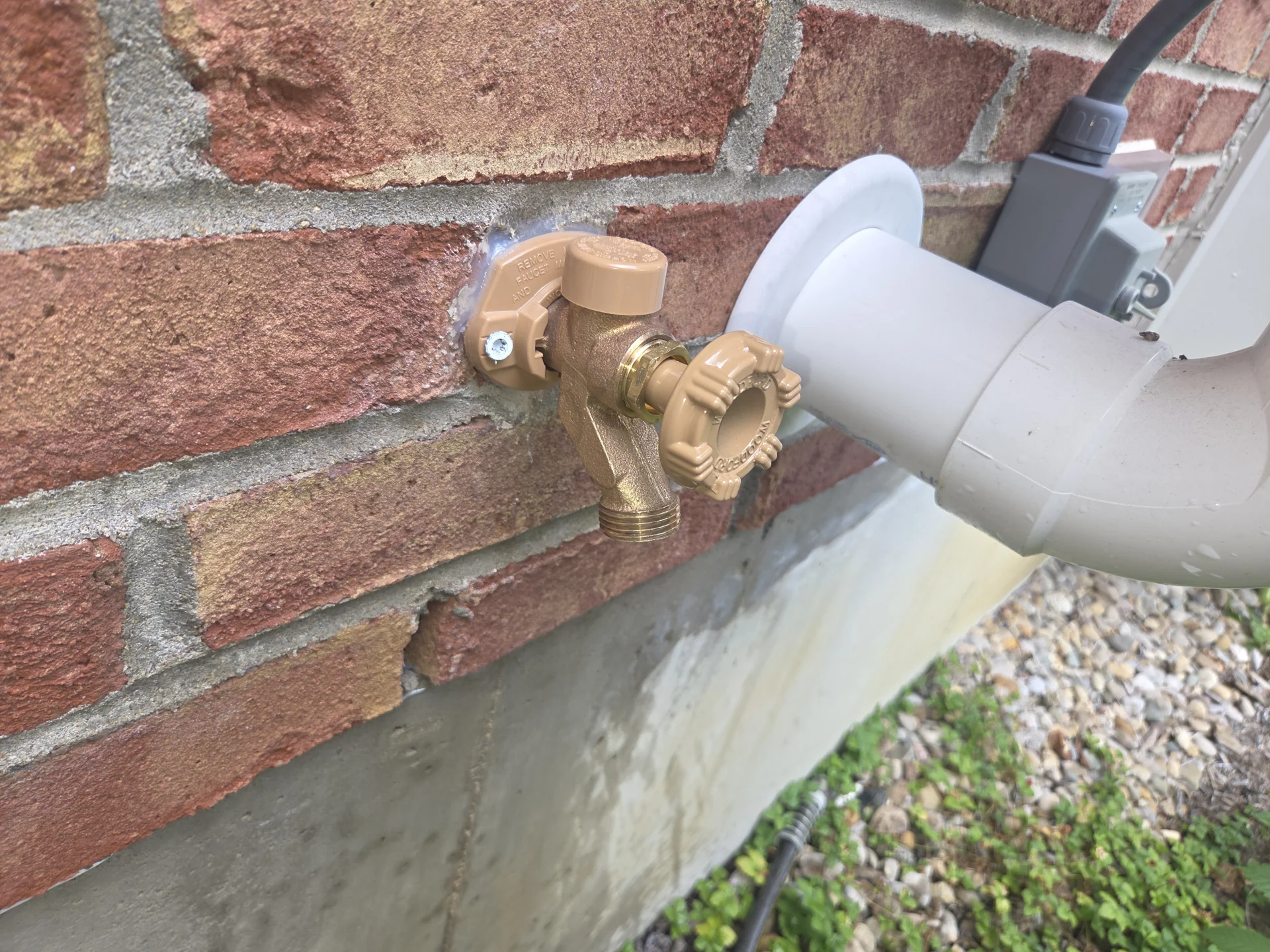 Outdoor water line on the brick exterior of a Beavercreek area home