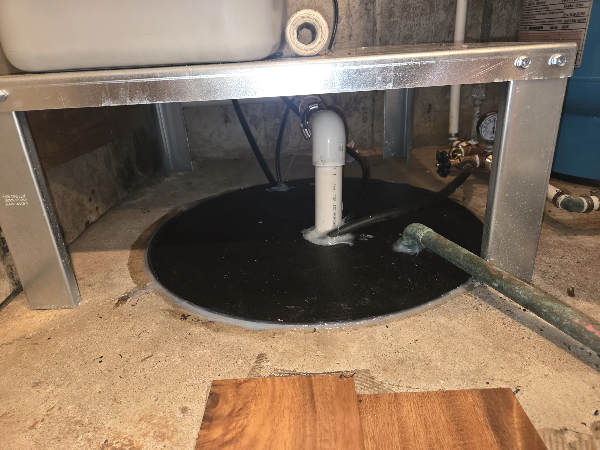 Sump pump fitted with a radon-blocking pit cover in a Dayton home