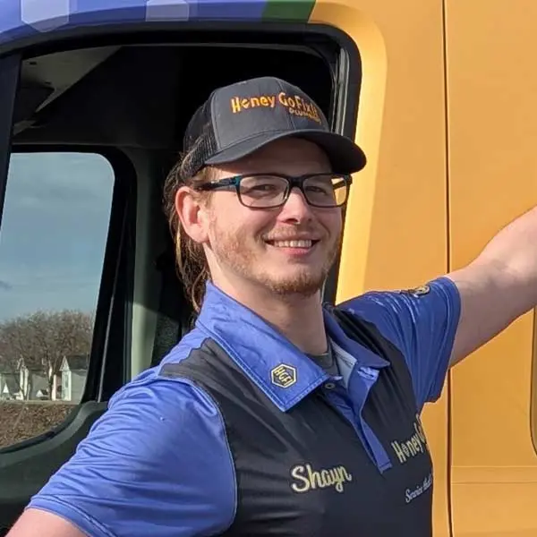 Licensed plumber Shayn from Honey Go Fix It standing next to a branded plumbing service truck in Dayton, Ohio, representing trusted local residential plumbing service.